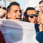 French sports supporters posing with a flag.