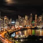 Brightly lit buildings in Panama City by night.